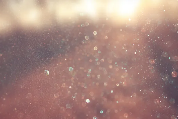 Blurred abstract photo of light burst among trees and glitter bokeh lights. filtered image and textured. — Stock Photo, Image