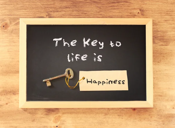 The phrase the key to life is happiness written on blackboard — Stock Photo, Image