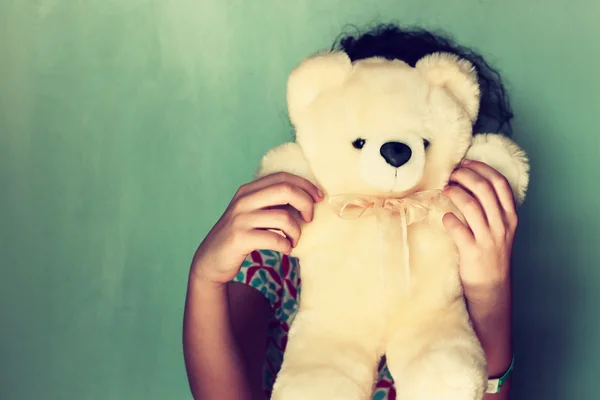 Little kid hiding behind teddy bear — Stock Photo, Image