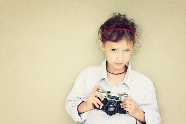 Cute kid photographer holding vintage camera — Stock Photo, Image