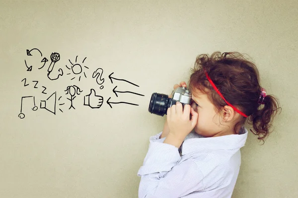 Concept of cute kid looking through vintage camera — Stock Photo, Image