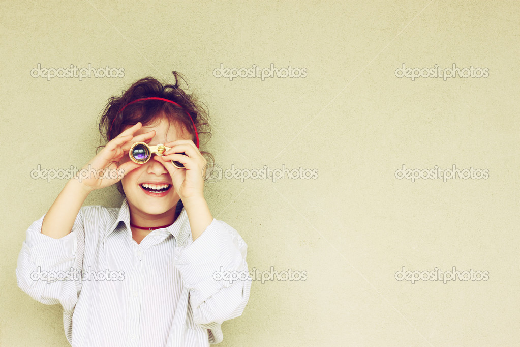 Happy kid playing with binoculars
