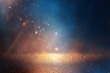 Soyut parıltılı ışıkların arkaplanı. Altın, mavi ve siyah. & Odaklan