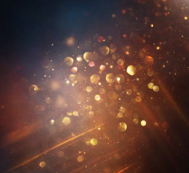 Soyut altın ve siyah parıltılı ışıkların arkaplanı. Odaklanamadı