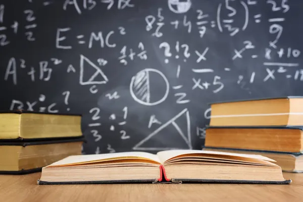 Schulbücher Auf Dem Schreibtisch Vor Der Tafel Mit Formeln Bildungskonzept — Stockfoto