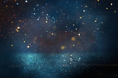 Soyut parıltılı ışıkların arkaplanı. Altın, mavi ve siyah. & Odaklan