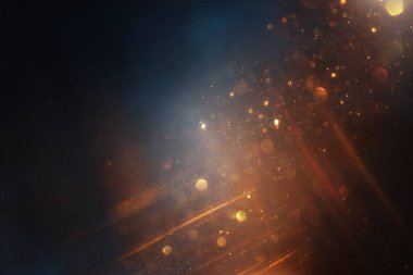 Soyut parıltılı ışıkların arkaplanı. Altın, mavi ve siyah. & Odaklan