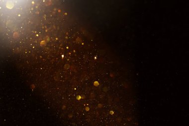 Soyut altın ve siyah parıltılı ışıkların arkaplanı. Odaklanamadı