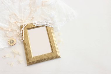 Beyaz, narin dantel kumaş, kuru çiçekler ve incilerin arka planı