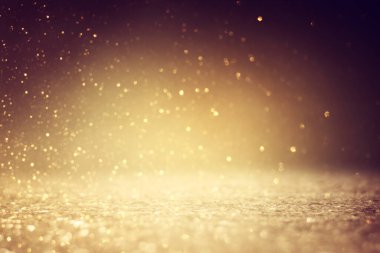 Soyut altın ve siyah parıltılı ışıkların arkaplanı. Odaklanamadı