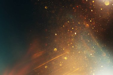 Soyut altın ve siyah parıltılı ışıkların arkaplanı. Odaklanamadı