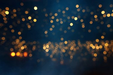 Soyut parıltılı ışıkların arkaplanı. Altın, mavi ve siyah. & Odaklan