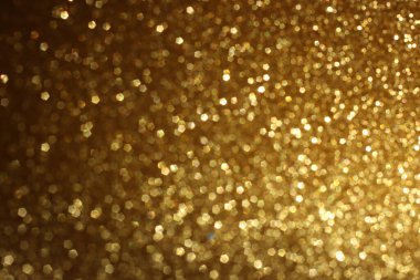 Soyut altın ve siyah parıltılı ışıkların arkaplanı. Odaklanamadı
