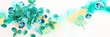 Zümrüt ve yeşil ortanca çiçeklerinin sanatsal arkaplandaki yaratıcı görüntüsü. Kopyalama alanı olan üst görünüm