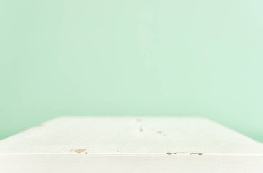 Background of wooden white table for displaying products. Pastel colors