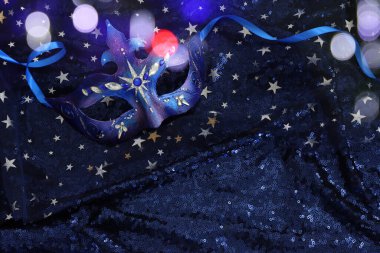 Mavi siyah yıldızların arka planında zarif ve narin Venedik maskesinin fotoğrafı