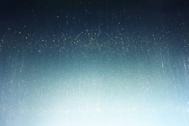 Karanlık gökyüzünde soyut parıltılı yıldızlar parlıyor