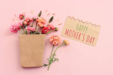 mother's day concept with pink flowers over pastel background