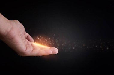 Human hand and magical glowing light