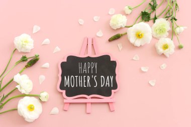 mother's day concept with pink flowers over pastel background