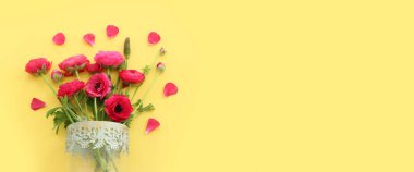 Top view image of pink flowers composition over yellow background