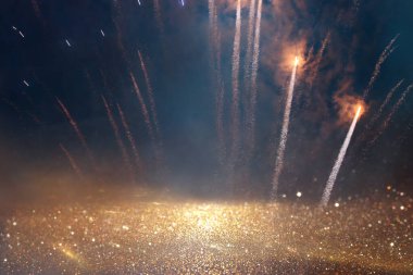 background of abstract gold, black and blue glitter lights with fireworks. defocused