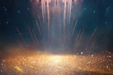 background of abstract gold, black and blue glitter lights with fireworks. defocused