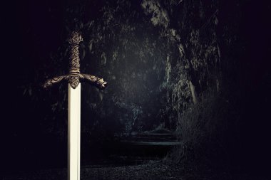 photo of knight sword over dark background. Medieval period concept