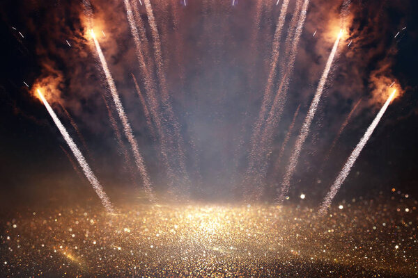 background of abstract gold and black glitter lights with fireworks. defocused