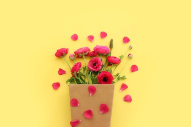 Sarı arkaplan üzerindeki pembe çiçeklerin üst görünümü