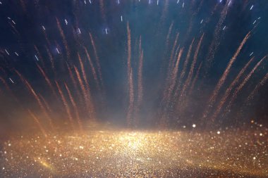 background of abstract gold, black and blue glitter lights with fireworks. defocused