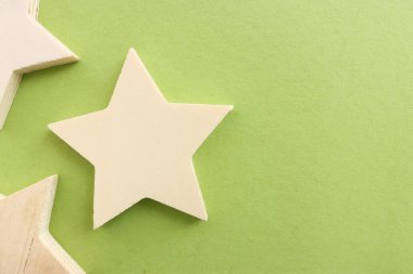 Kalıplı yeşil arkaplan üzerindeki ahşap yıldızın üst görünümü