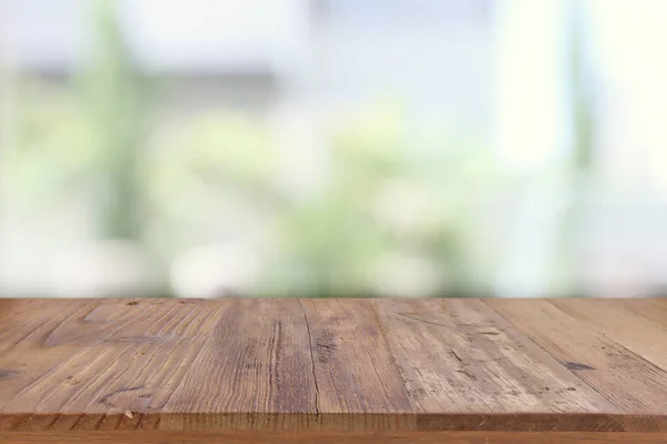 empty table board and defocused indoor background. product display concept