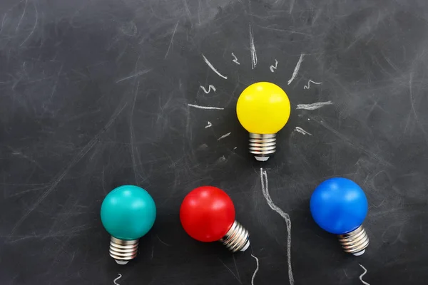 Education concept image. Creative idea and innovation. light bulb metaphor over blackboard background