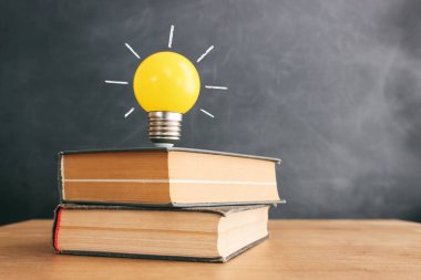 Education concept image. Creative idea and innovation. light bulb metaphor over blackboard background