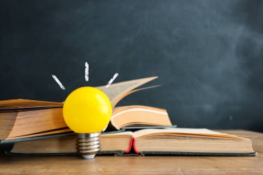 Education concept image. Creative idea and innovation. light bulb metaphor over blackboard background