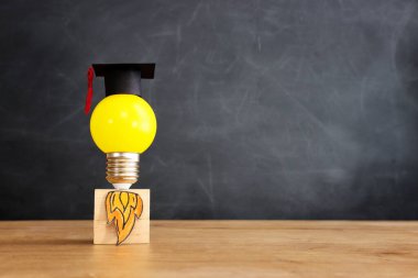 Education concept image. Creative idea and innovation. light bulb metaphor over blackboard background
