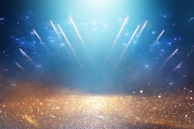 background of abstract black and blue glitter lights with fireworks. defocused