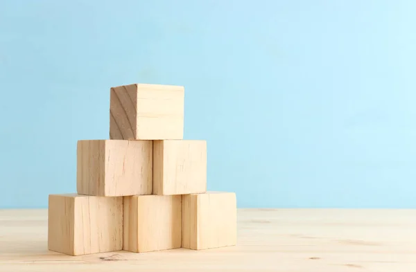 Stack of empty wooden cubes on table forming ladder