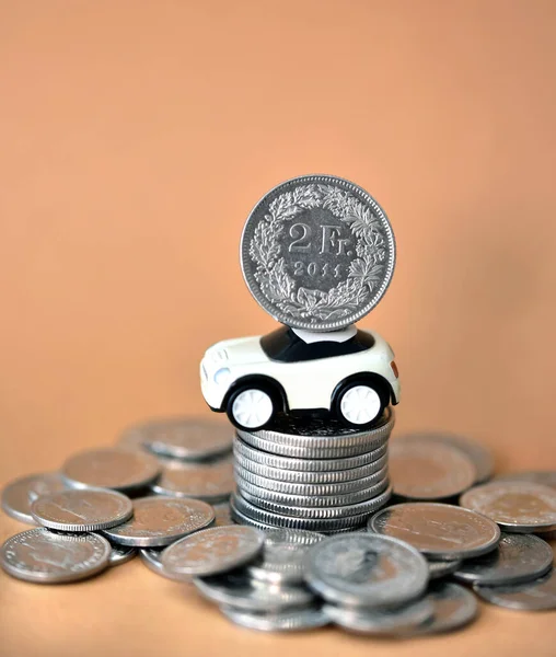 swiss money coins with small toy car