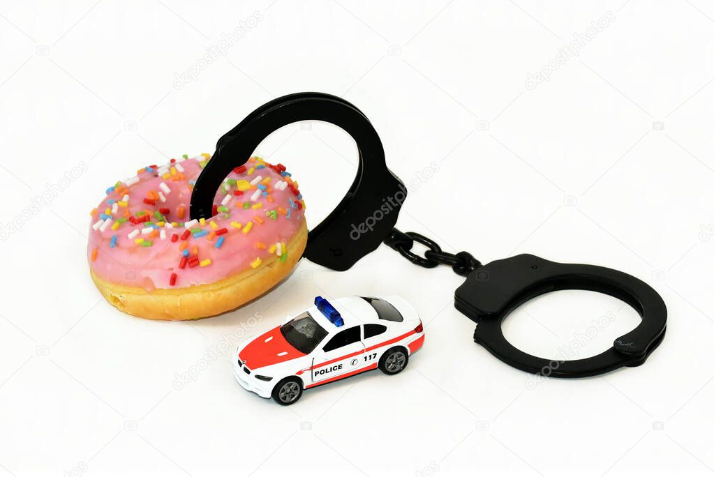 funny donut with handcuffs and police car