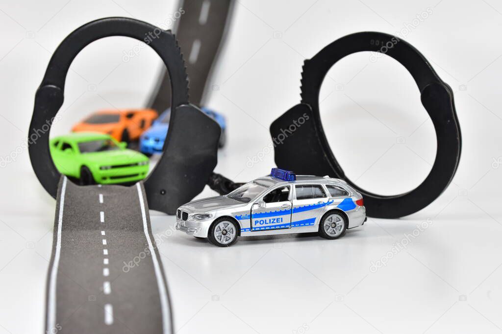 police car with handcuffs and traffic road