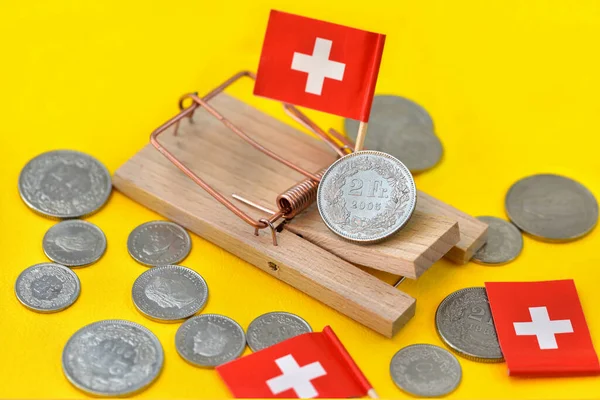 swiss money coins with mousetrap
