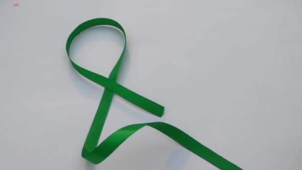 Green Ribbon White Background Table Top View Copy Space Text — Stock Video