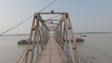 Gün batımında nehir kenarındaki bir köprüde nehir ufkuna karşı yürümek. Kolkata Batı Bengal Hindistan, Güney Asya Pasifik 28 Ekim 2021 Achipur Fırlatma Ghat