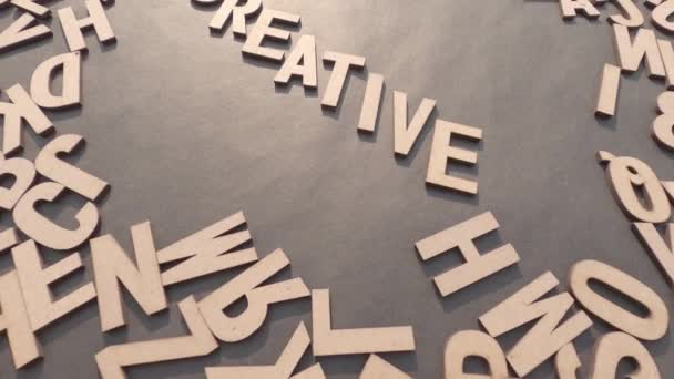 木製のキューブのアルファベット文字で創造的な言葉素朴な紙の背景の上のビュー — ストック動画