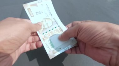 Masadaki Hint beşyüz banknotunu saymaya başla. Para sayımı finans ve iş konsepti. Yüksek Açı Görünümü.