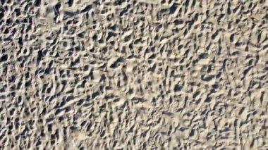 Soaring high above perfect sand