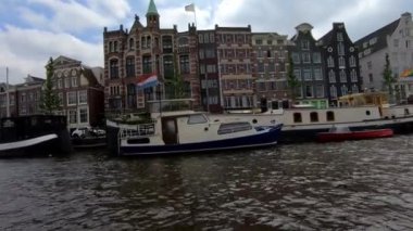 Beautiful private boats parked along a canal in Amsterdam