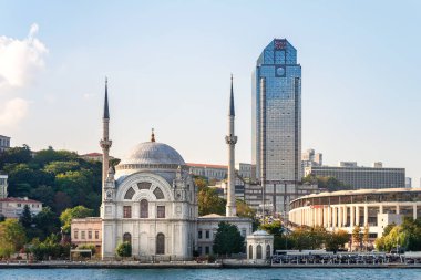 İstanbul Boğazı 'ndaki bir gökdelenin arka planındaki Dolmabahçe Camii. İstanbul. Türkiye - 09.25.2021.